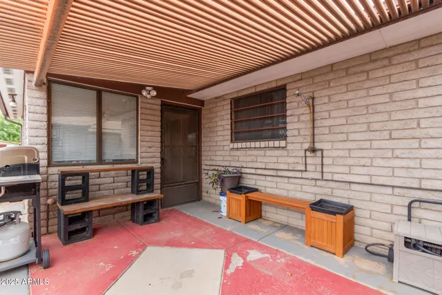 a view of a workspace with furniture and a flat screen tv