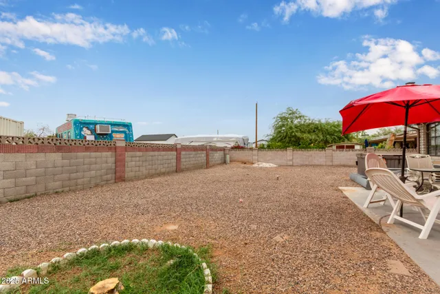 a backyard of a house with barbeque oven