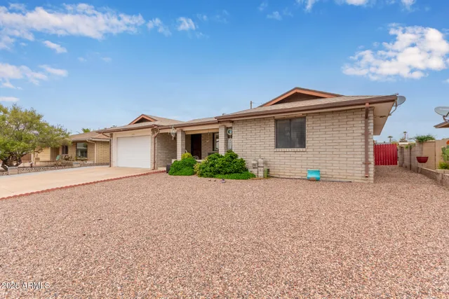 a front view of house with yard and trees