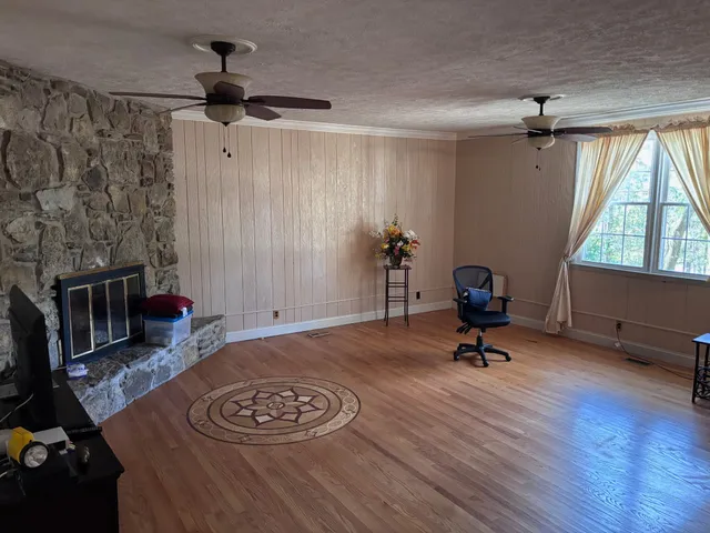 a view of a livingroom with workspace and a window