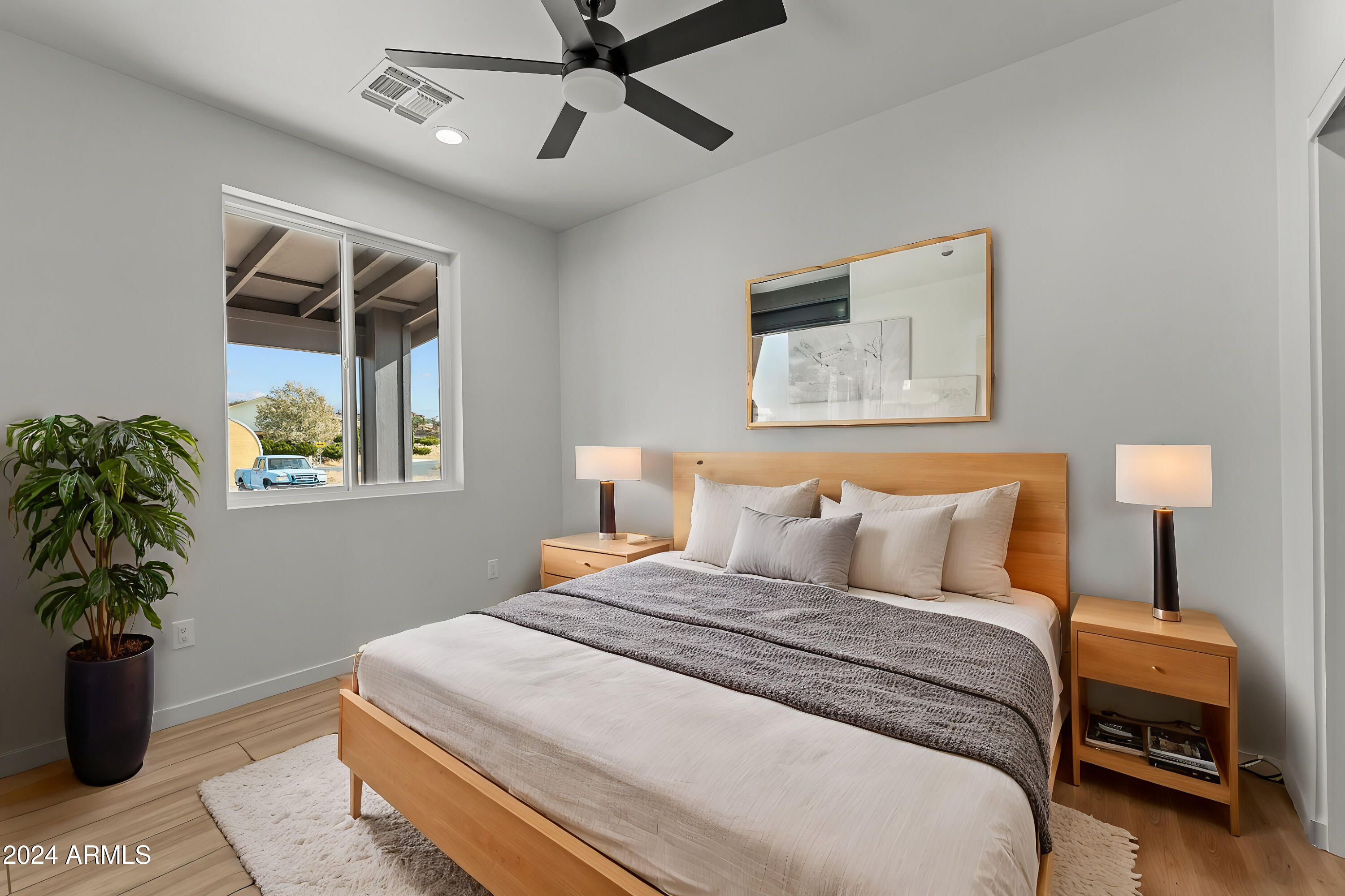 18473 Henry Coe Road Peeples Valley, AZ 86332 - Photo 23 of 31 a bedroom with a large bed and a potted plant