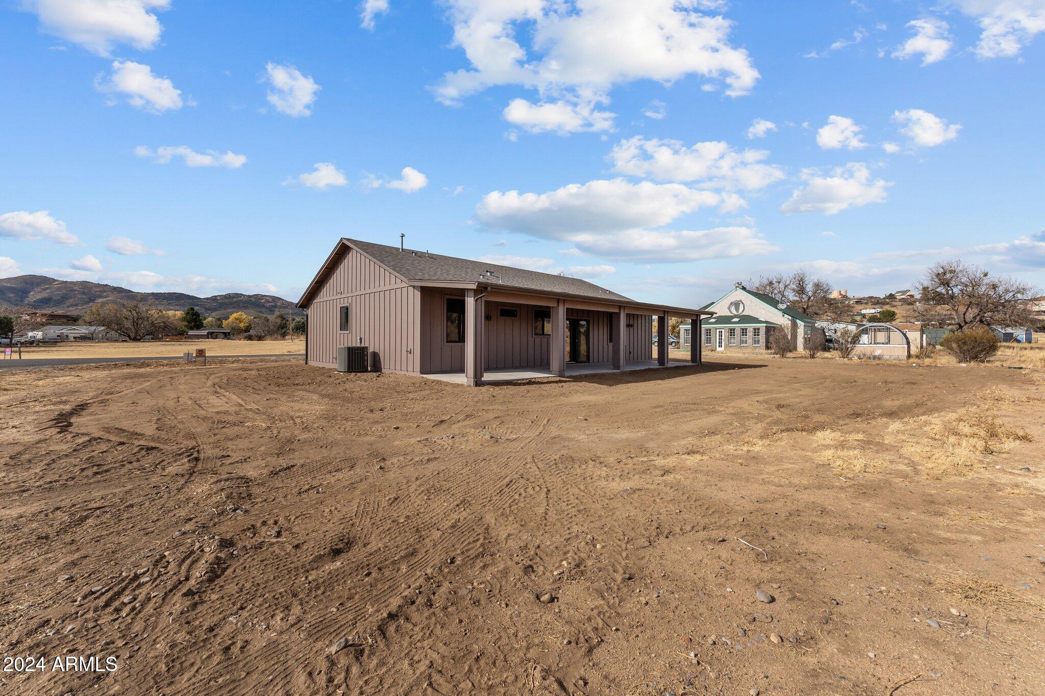 18473 Henry Coe Road Peeples Valley, AZ 86332 - Photo 29 of 31 a view of a house with a yard