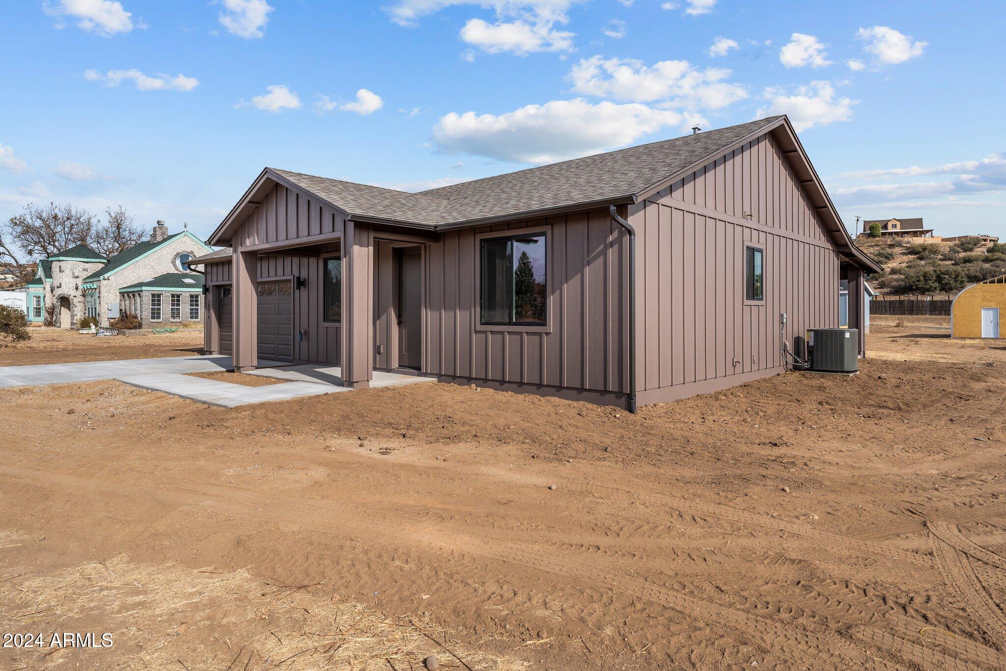 18473 Henry Coe Road Peeples Valley, AZ 86332 - Photo 30 of 31 a view of a house with a backyard