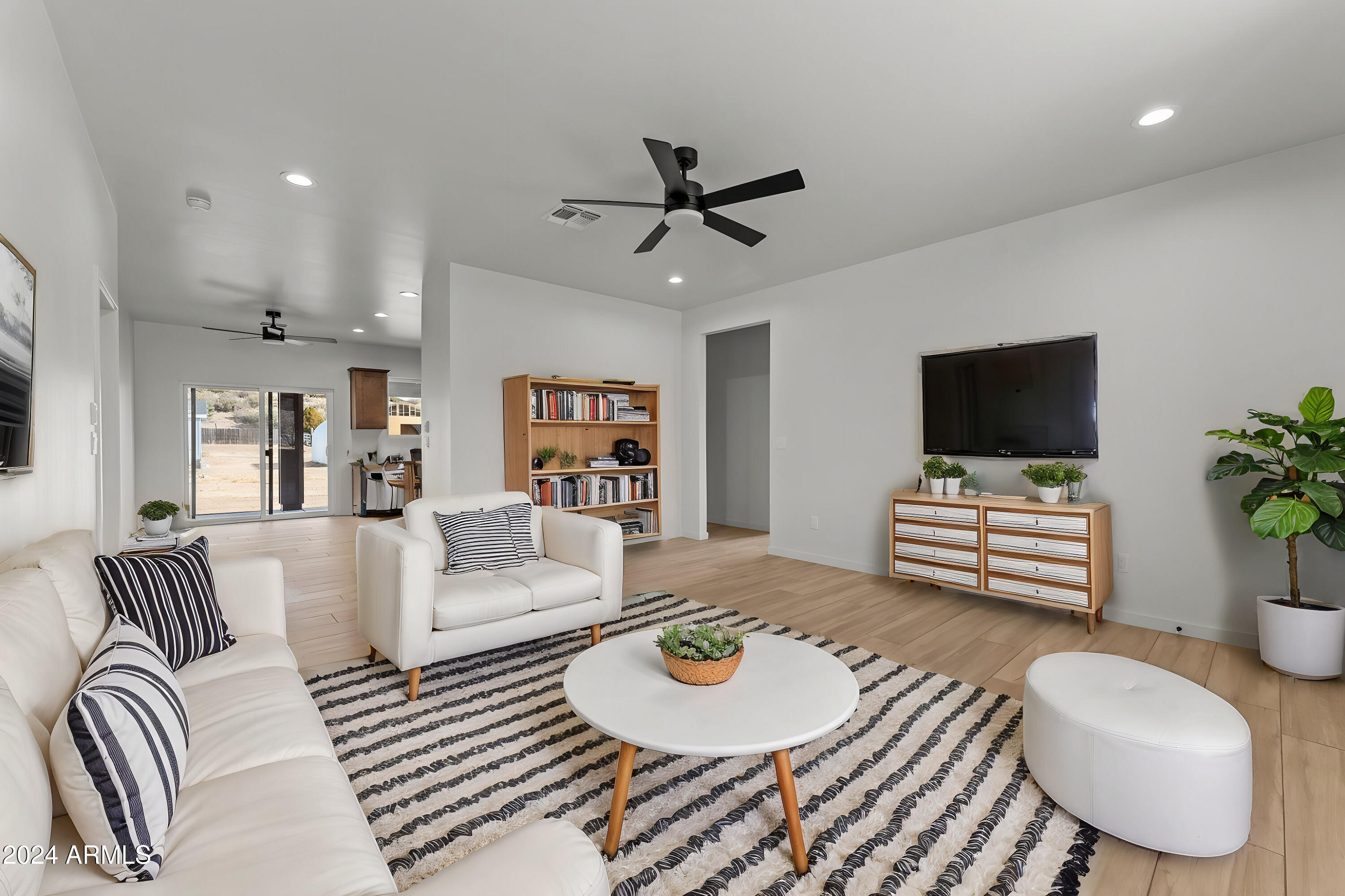 18473 Henry Coe Road Peeples Valley, AZ 86332 - Photo 4 of 31 a living room with furniture and a flat screen tv