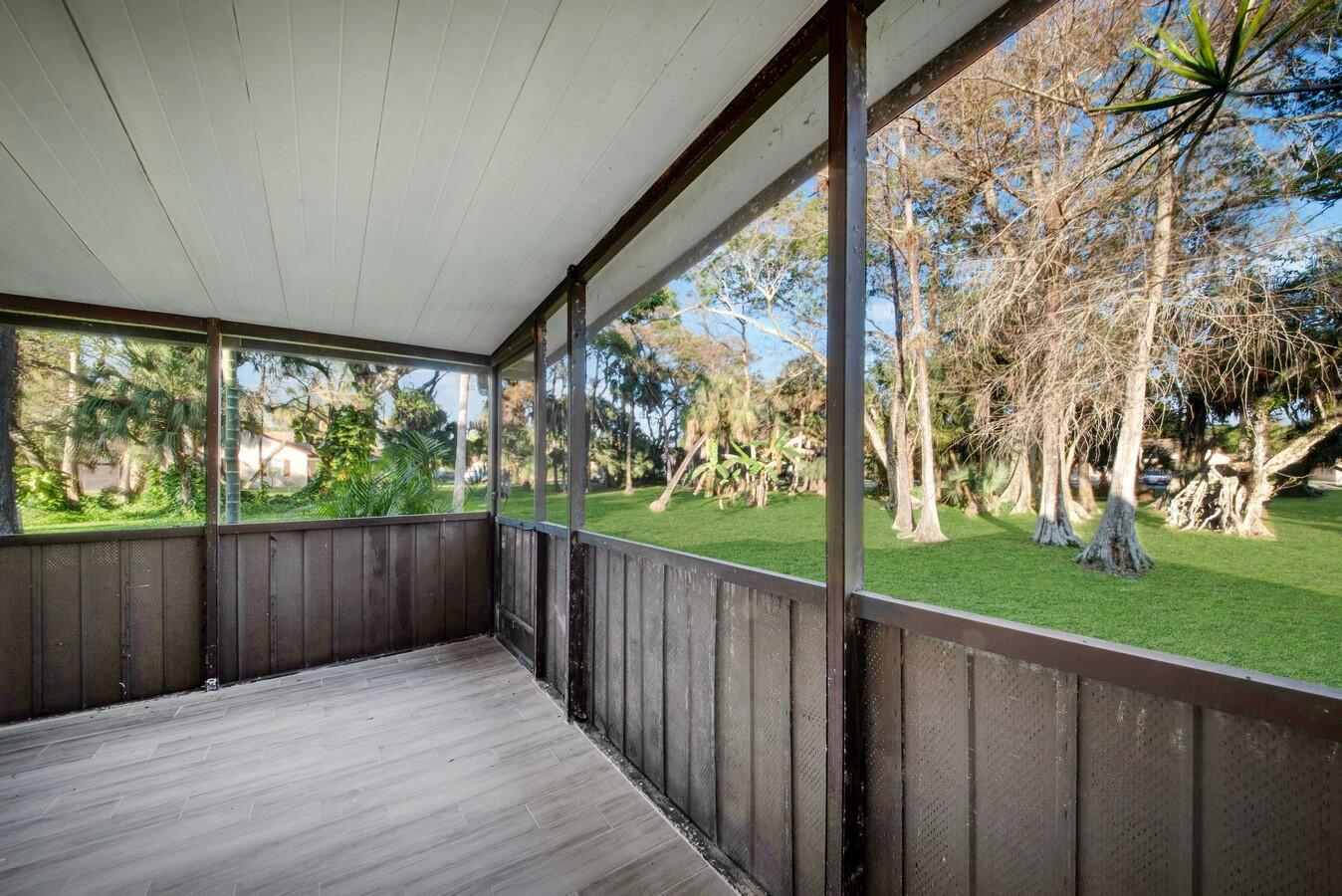 22355 Southwest 57th Circle Boca Raton, FL 33428 - Photo 11 of 25 a view of a porch with wooden fence and floor