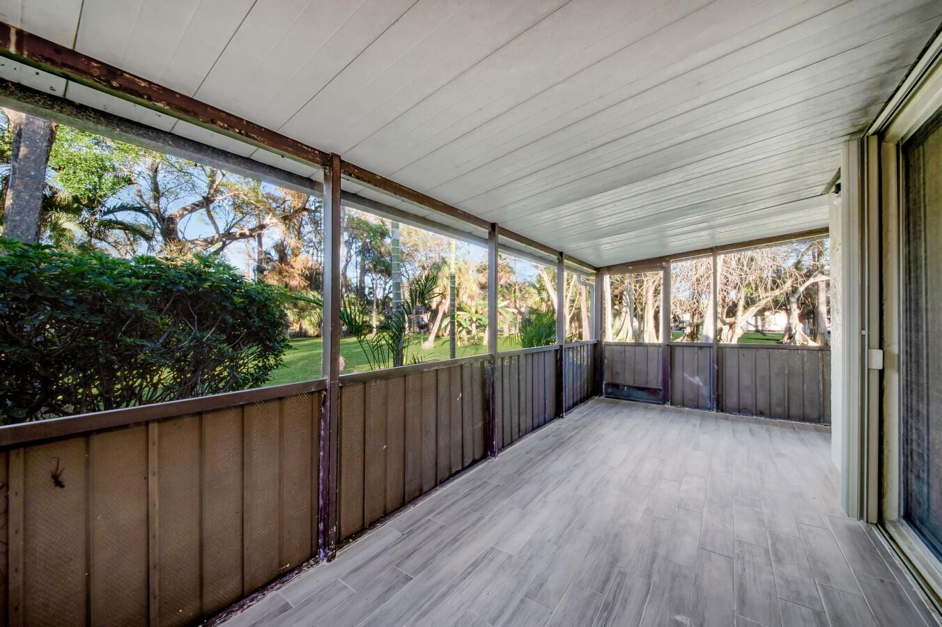22355 Southwest 57th Circle Boca Raton, FL 33428 - Photo 12 of 25 a view of hallway with a large window and wooden floor