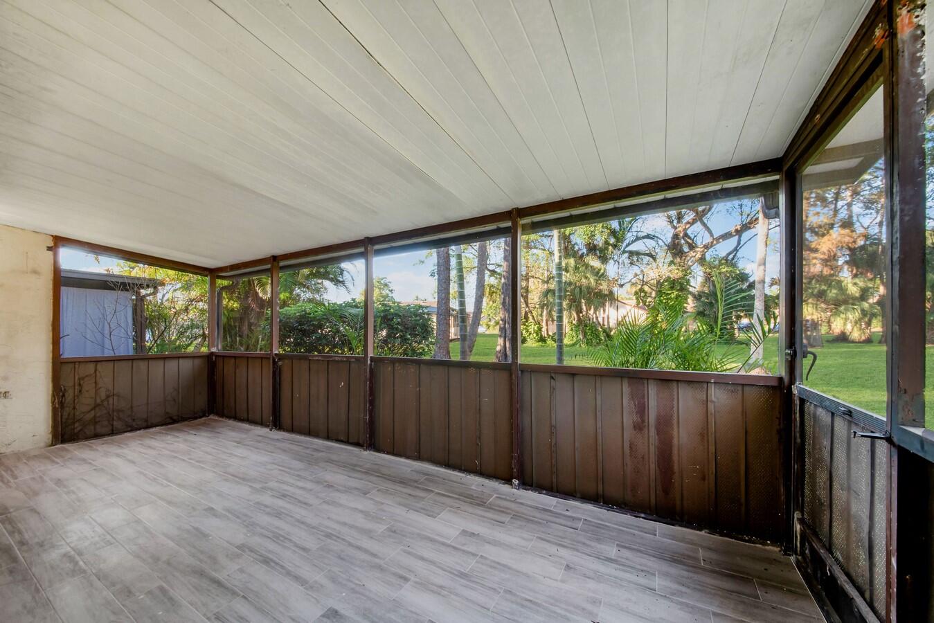 22355 Southwest 57th Circle Boca Raton, FL 33428 - Photo 13 of 25 wooden floor in an empty room with large windows
