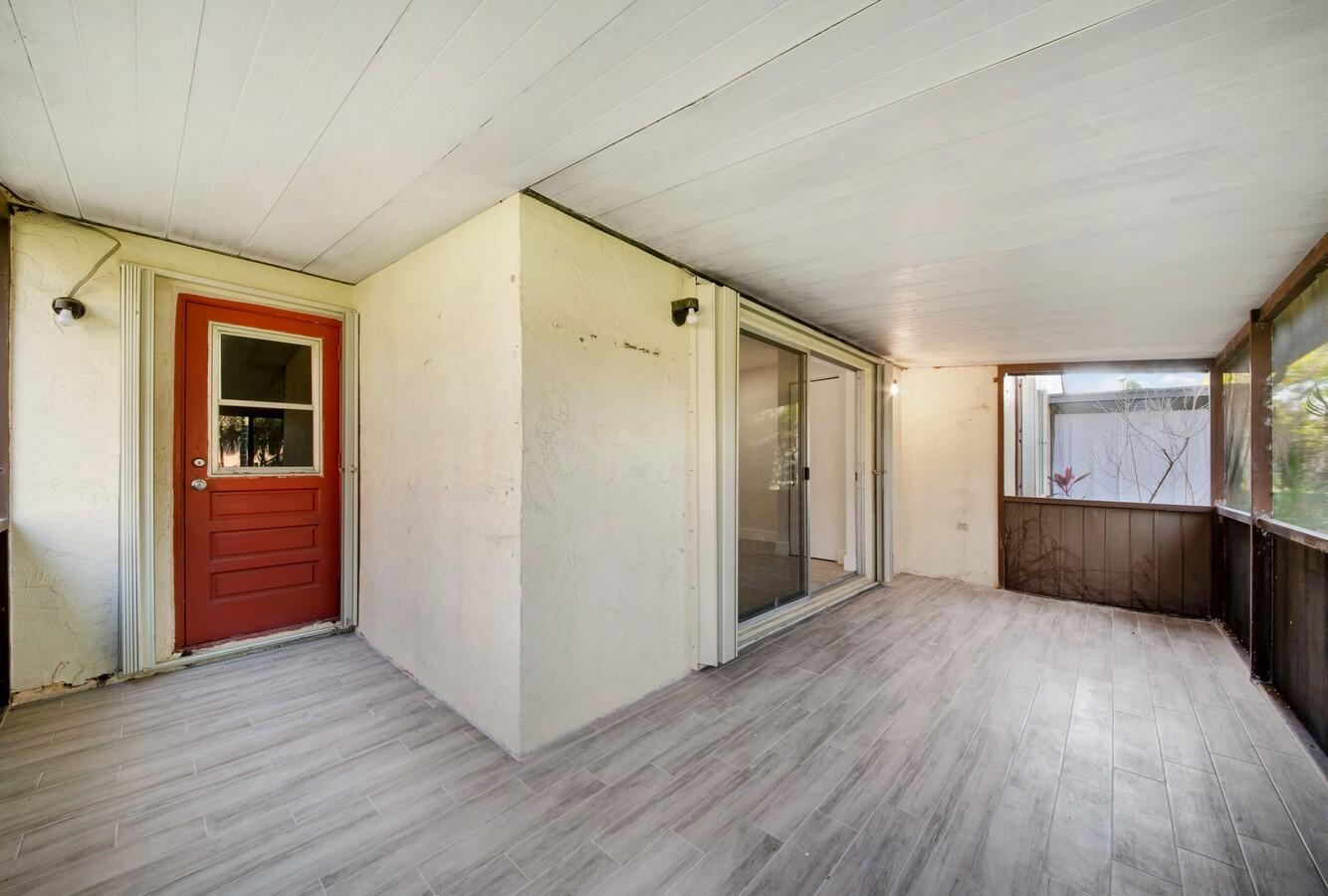 22355 Southwest 57th Circle Boca Raton, FL 33428 - Photo 14 of 25 an empty room with wooden floor and windows