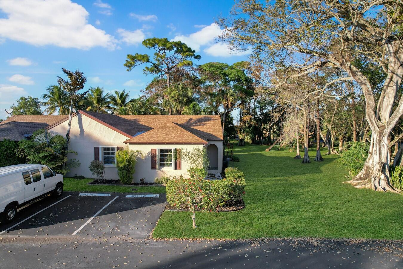 22355 Southwest 57th Circle Boca Raton, FL 33428 - Photo 18 of 25 a front view of a house with a yard