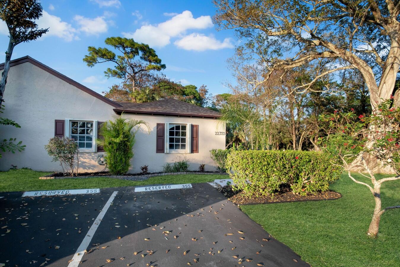 22355 Southwest 57th Circle Boca Raton, FL 33428 - Photo 21 of 25 a front view of a house with garden