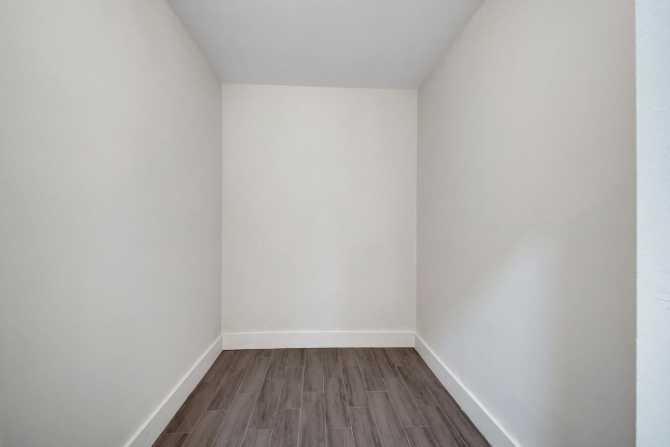 22355 Southwest 57th Circle Boca Raton, FL 33428 - Photo 6 of 25 a view of a small space with wooden floor and a window