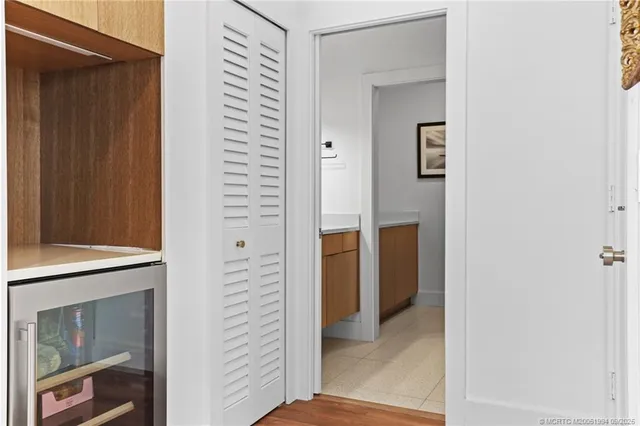 a view of a hallway with closet and a window