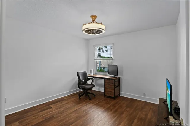 a view of a workspace with wooden floor