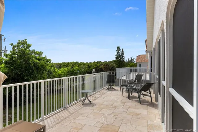 a balcony with table and chairs