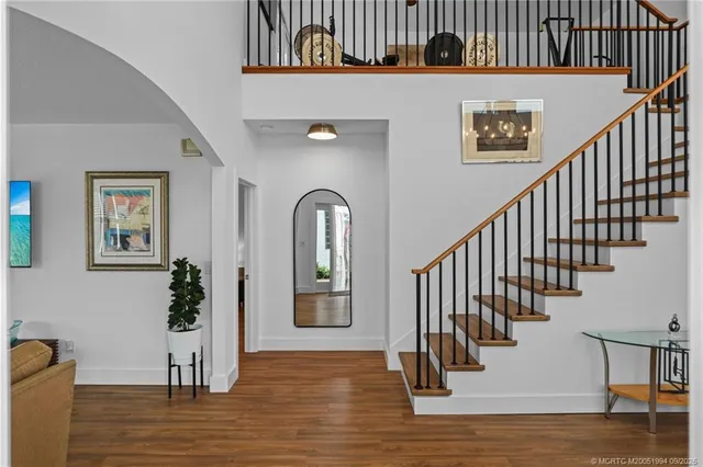 a view of entryway and hall with wooden floor