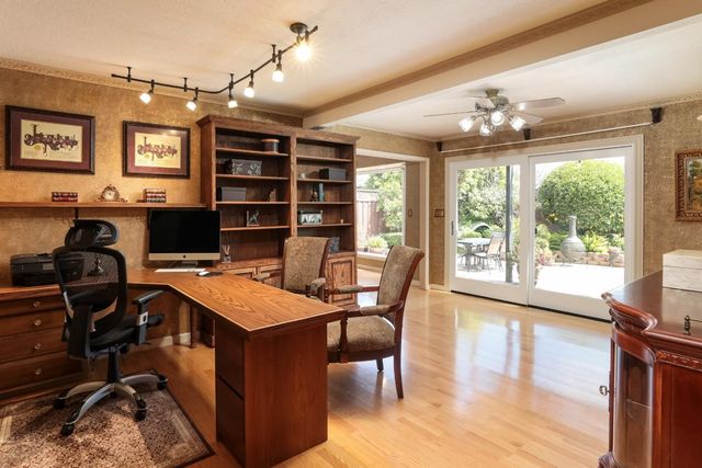 a view of a workspace with furniture window and wooden floor