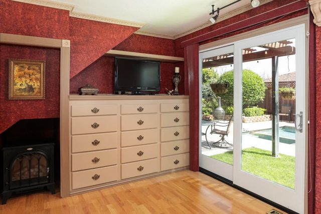 a view of room with window and dresser