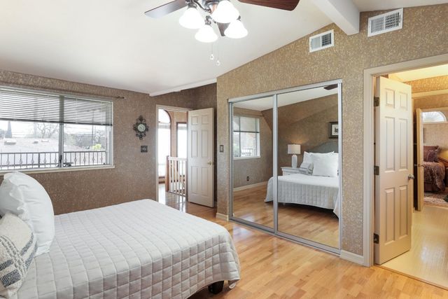 a bedroom with a large bed and a chandelier