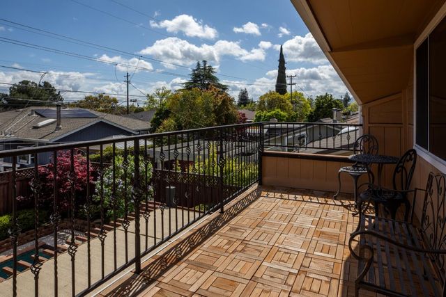 a view of a balcony with wooden floor