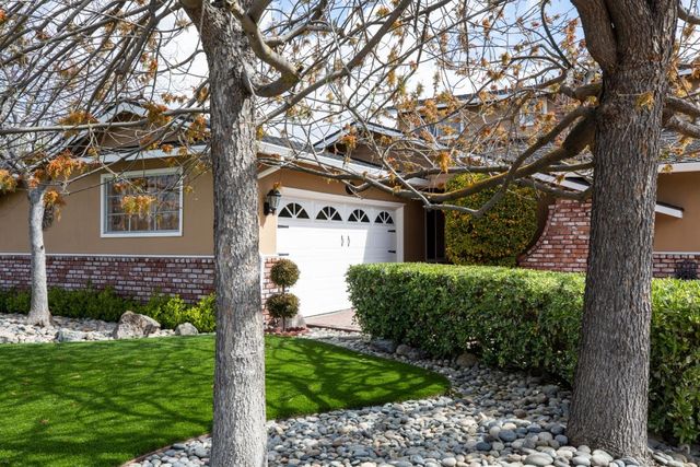 a view of a house with a tree in a yard