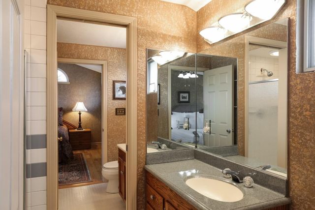 a en suite bathroom with a sink and a mirror