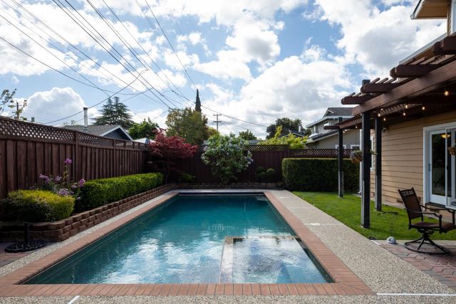 a view of a backyard with sitting area