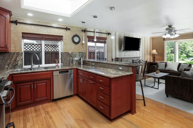 a spacious bathroom with a granite countertop sink and a large mirror