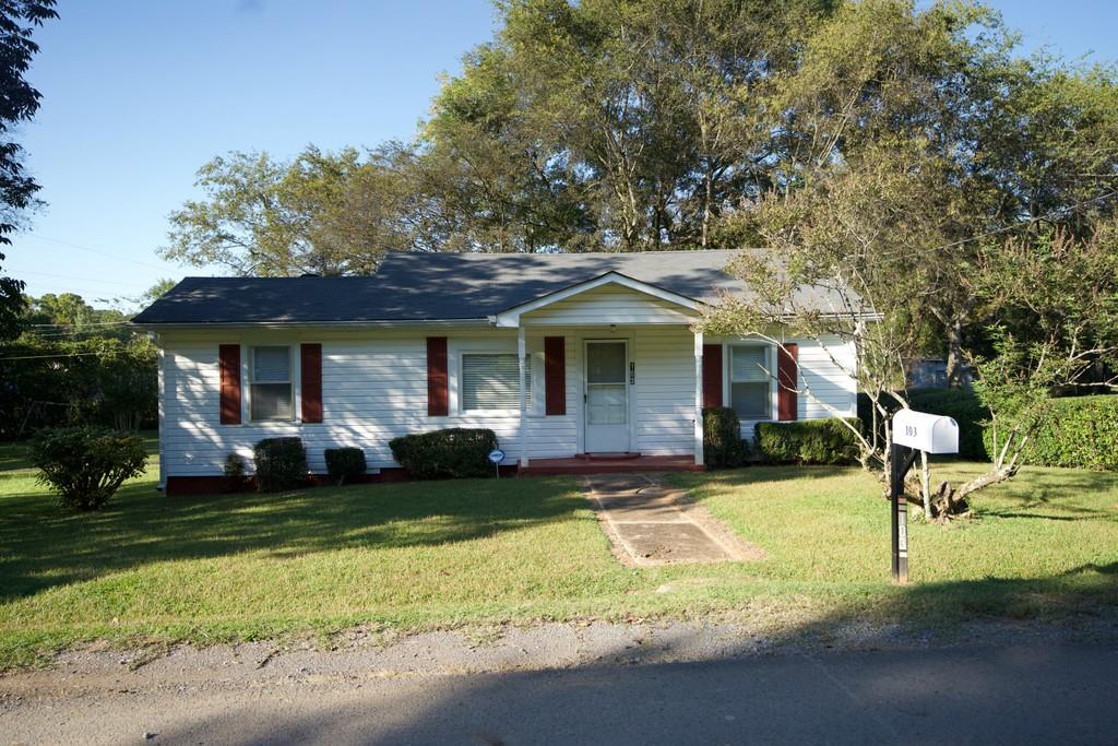 103 Thomas Road Northeast Rome, GA 30161 - Photo 1 of 1 a front view of a house with a garden and trees