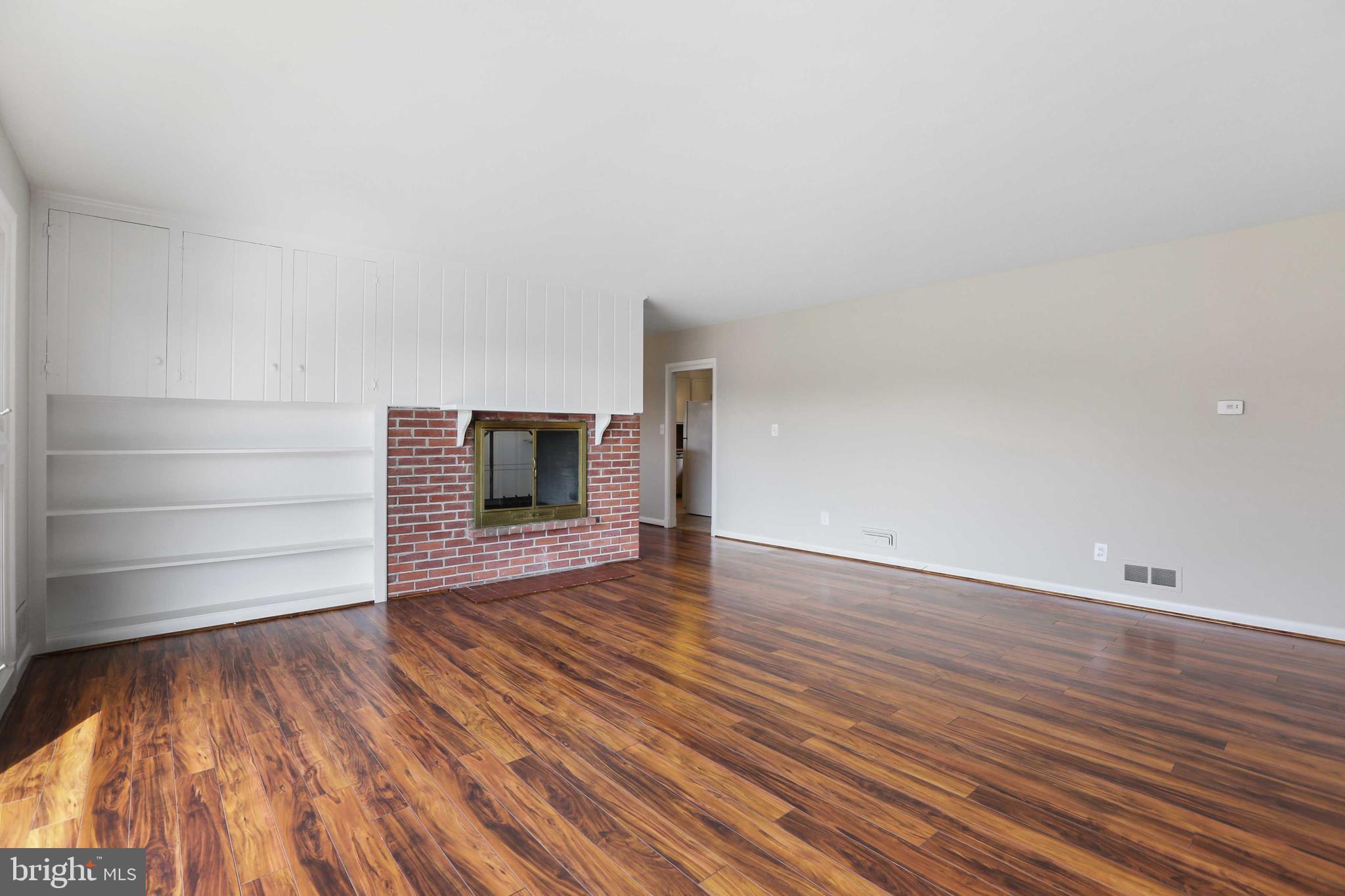 6701 Canongate Road Baltimore, MD 21239 - Photo 10 of 27 LIVING ROOM WITH DOUBLE SIDED FIREPLACE