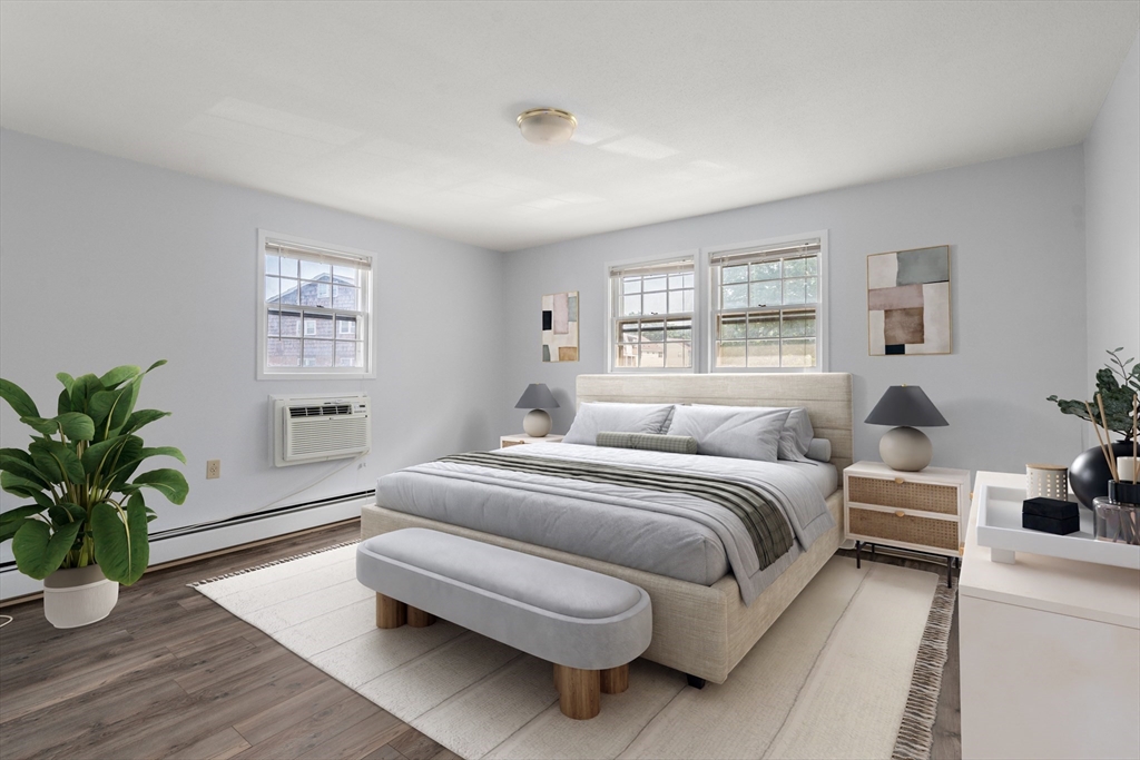 88 Beacon Street, Unit 7 Lawrence, MA 01843 - Photo 13 of 34 a spacious bedroom with a bed and wooden floor