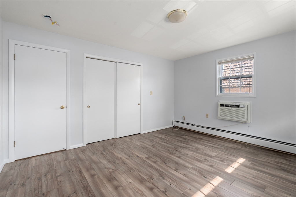 88 Beacon Street, Unit 7 Lawrence, MA 01843 - Photo 14 of 34 a view of empty room with wooden floor and fan