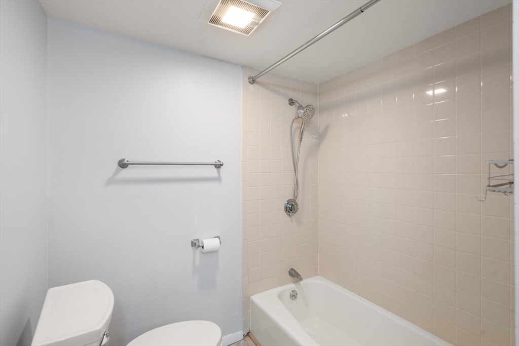 88 Beacon Street, Unit 7 Lawrence, MA 01843 - Photo 19 of 34 a bathroom with a toilet a sink a mirror and vanity