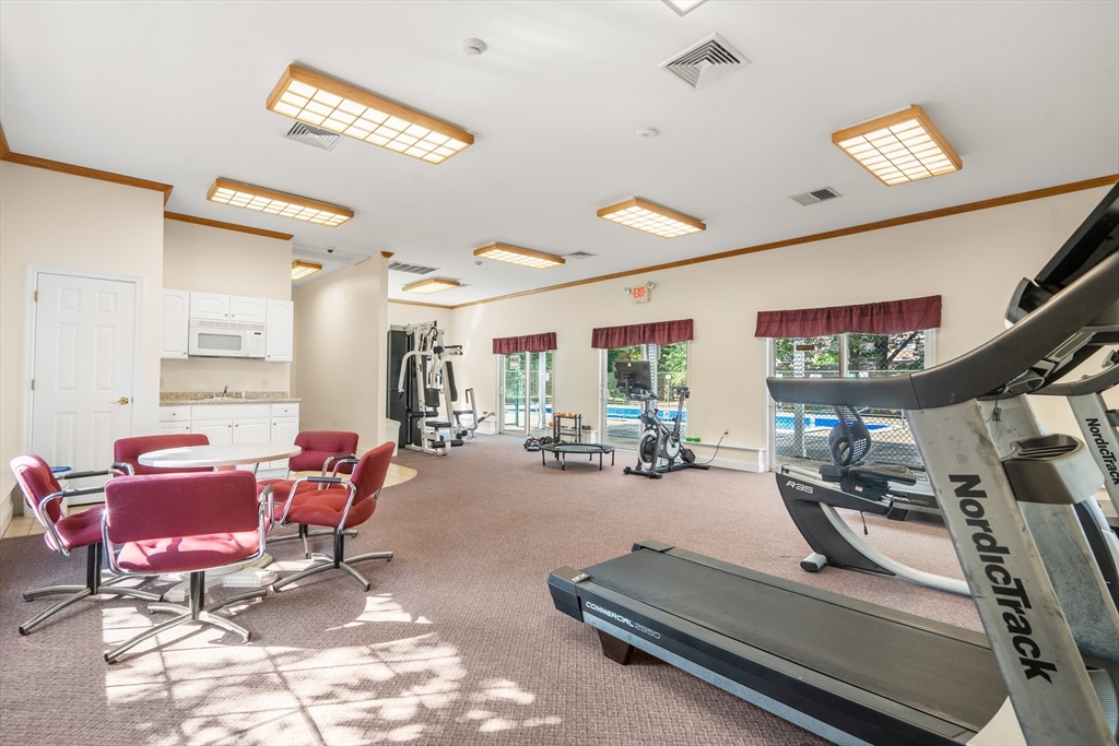 88 Beacon Street, Unit 7 Lawrence, MA 01843 - Photo 30 of 34 a room with gym equipment and a large window