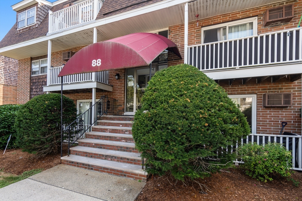 88 Beacon Street, Unit 7 Lawrence, MA 01843 - Photo 3 of 34 a front view of a house with a yard