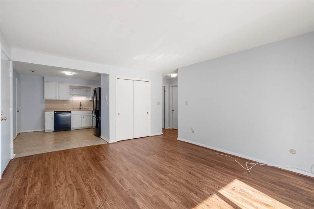 88 Beacon Street, Unit 7 Lawrence, MA 01843 - Photo 8 of 34 a view of a kitchen with wooden floor and a sink