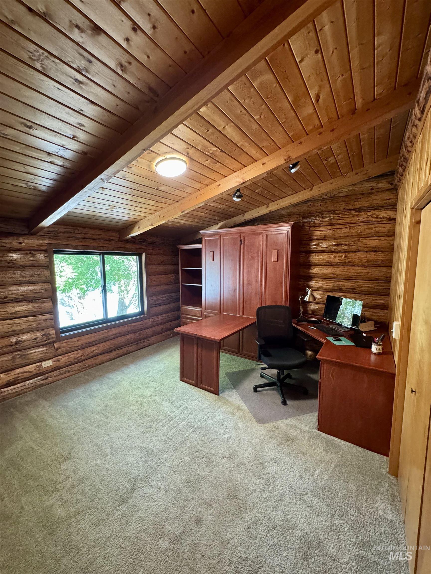 62 Bell Rapids Road Hagerman, ID 83332 - Photo 23 of 34 Room featuring natural log walls, wood-paneled vaulted ceiling, and built-in cabinetry