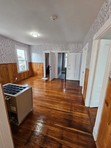 a living room with hard wood floors and furniture
