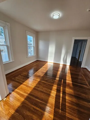 a view of bedroom with wooden floor