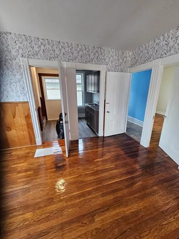 a view of a livingroom with wooden floor and staircase