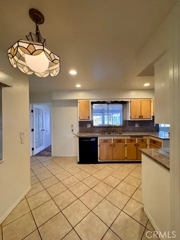 a kitchen with stainless steel appliances granite countertop a sink and cabinets