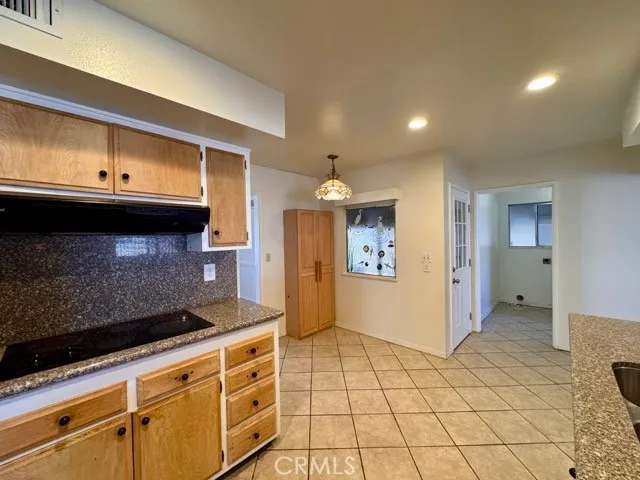 a kitchen with stainless steel appliances a sink stove and cabinets