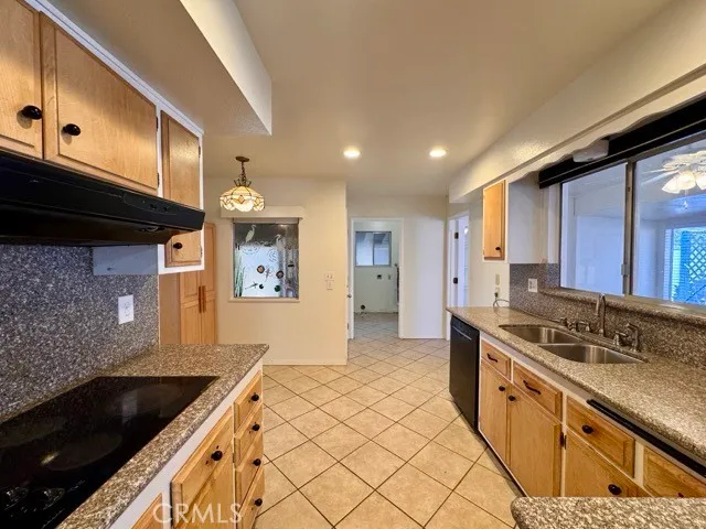 a kitchen with stainless steel appliances granite countertop a sink and a stove