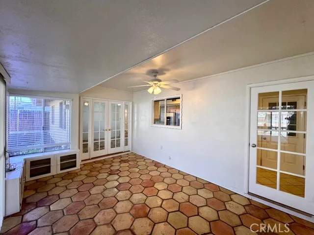 a bedroom with a bed and a flat tv screen next to a window