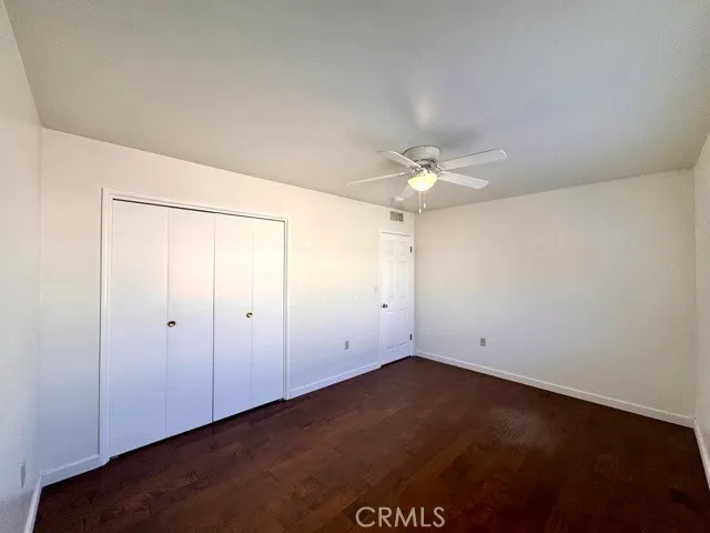 an empty room with a ceiling fan and a window