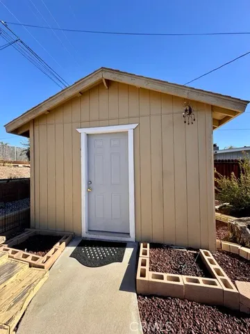 a view of a house with wooden floor and a ceiling fan