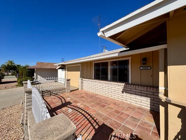 a view of a patio with table and chairs with wooden floor and fence