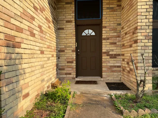 a brick building with a sign on it