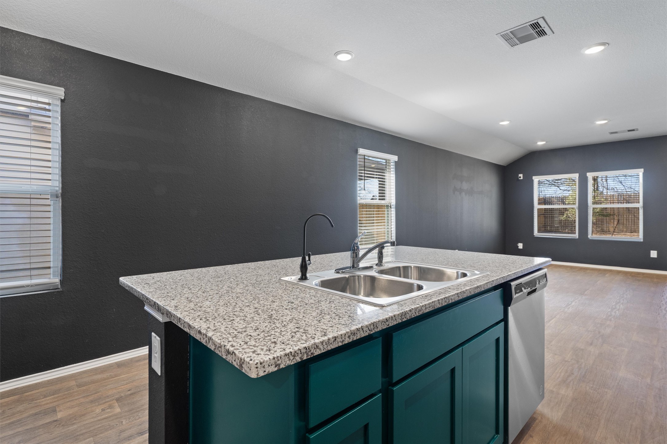 352 Sickle Loop Uhland, TX 78640 - Photo 13 of 36 a kitchen with granite countertop kitchen island stainless steel appliances a sink stove and window