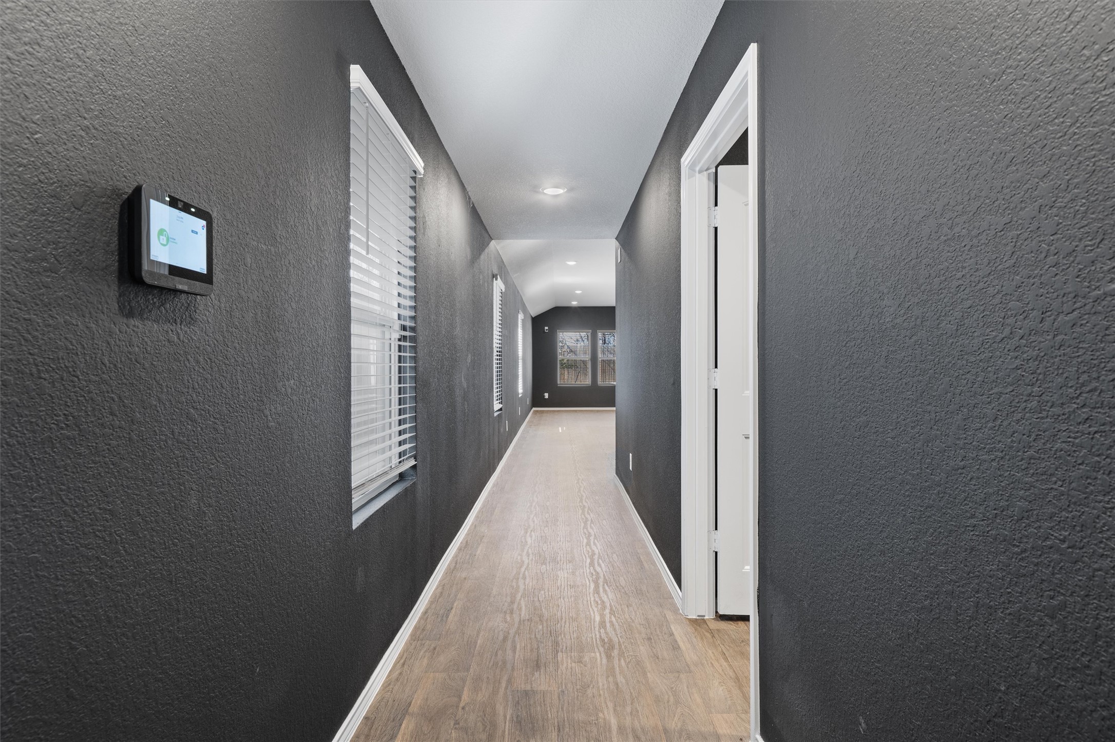 352 Sickle Loop Uhland, TX 78640 - Photo 7 of 36 a view of a hallway with wooden floor and a mirror