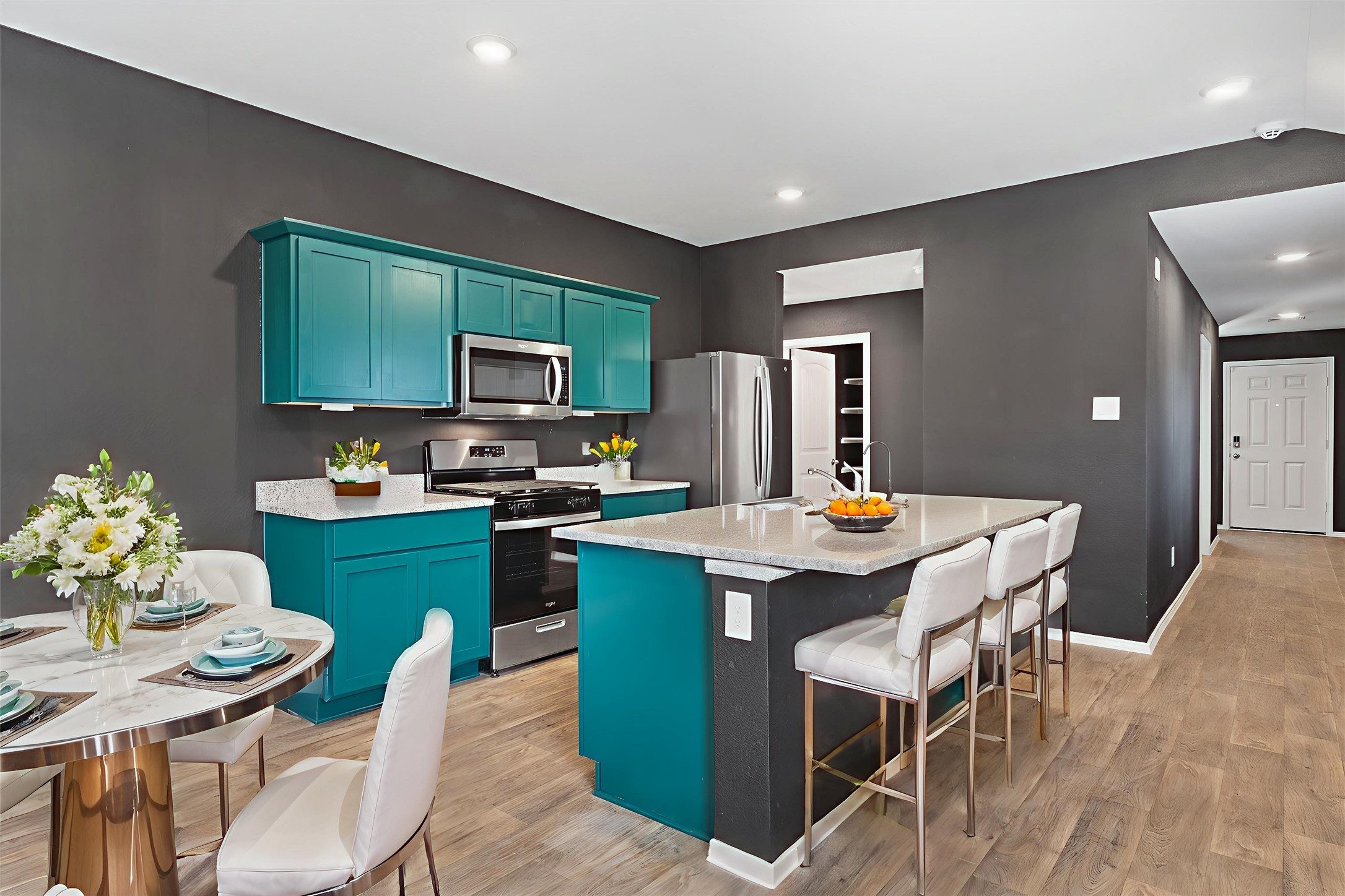352 Sickle Loop Uhland, TX 78640 - Photo 8 of 36 a kitchen with a dining table chairs and a refrigerator
